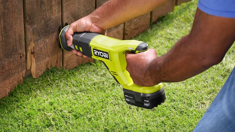 Ryobi reciprocating saw cutting a fence panel