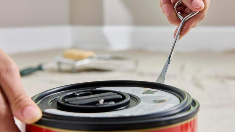 A can of paint opened with a can opener.