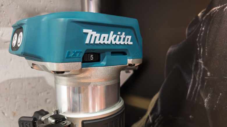 Closeup of a Makita cordless router showing the brand's logo