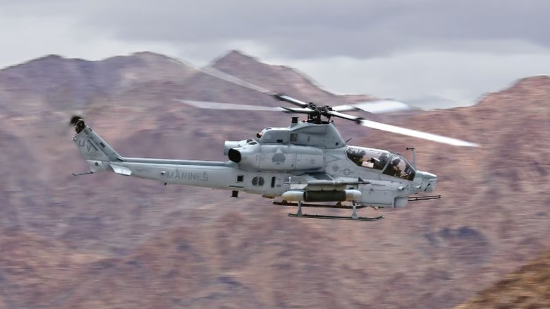 The Bell AH-1Z Viper flying over a mountain range