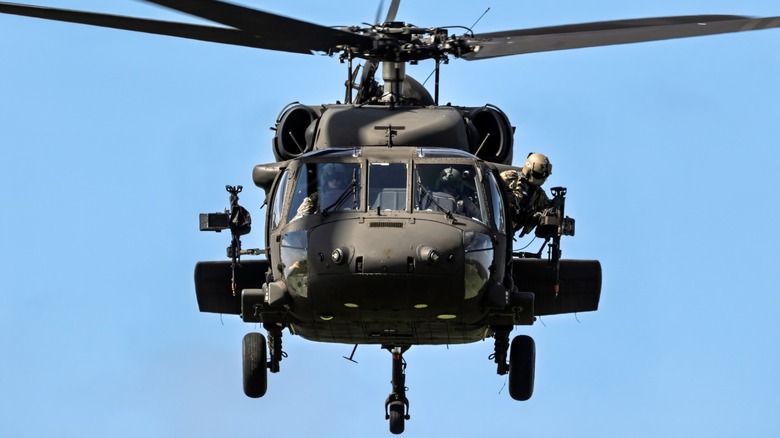A Black Hawk helicopter carrying military personnel