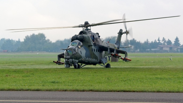 The Mil Mi-24 Hind taking off from a field
