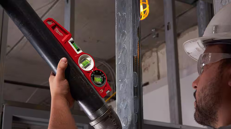 Milwaukee 10 inch torpedo level used on a jobsite