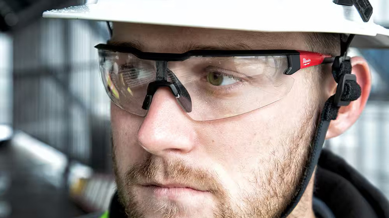 Worker wearing Milwaukee clear safety glasses