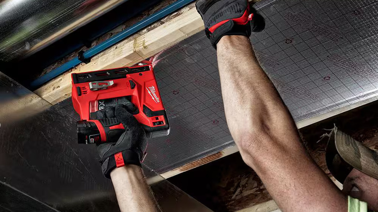 Worker uses a Milwaukee M12 crown stapler