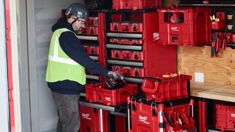 Worker using Milwaukee Packout storage system