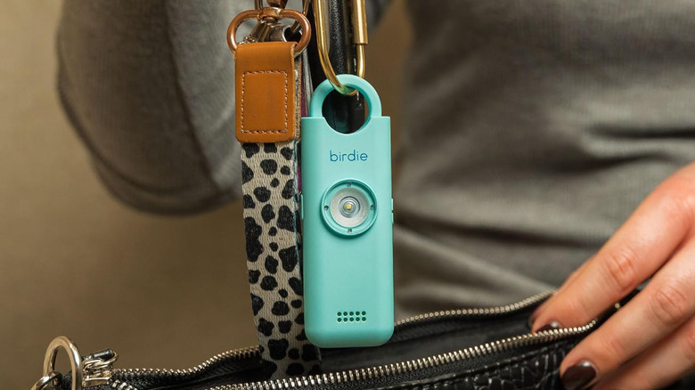 The She's Birdie 3.0 being slipped into a purse.
