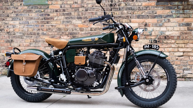 Janus Halcyon 450cc motorcycle parked on concrete in front of a brick wall