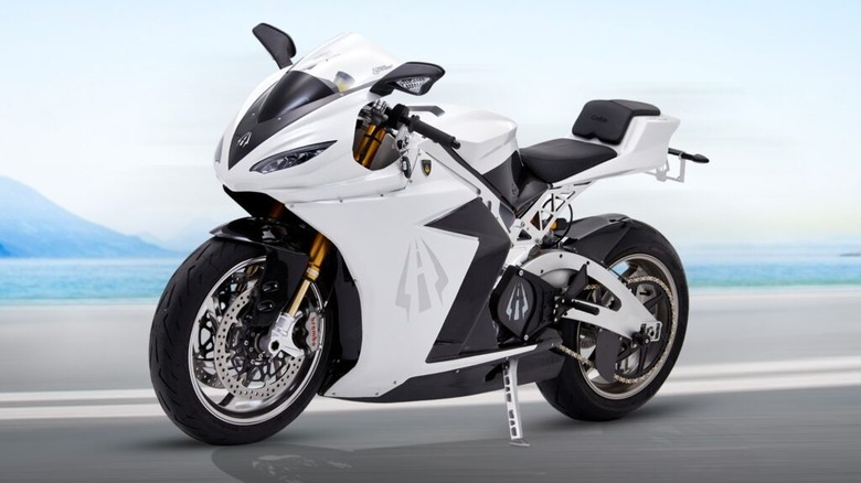 A white Lightning Motorcycle sport bike parked on a shiny surface with a beach background
