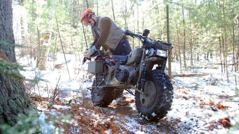 Person in the woods with a Rokon motorcycle