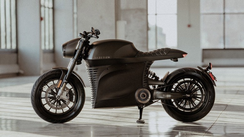 Tarform Luna motorcycle inside a building with light coming through the many windows