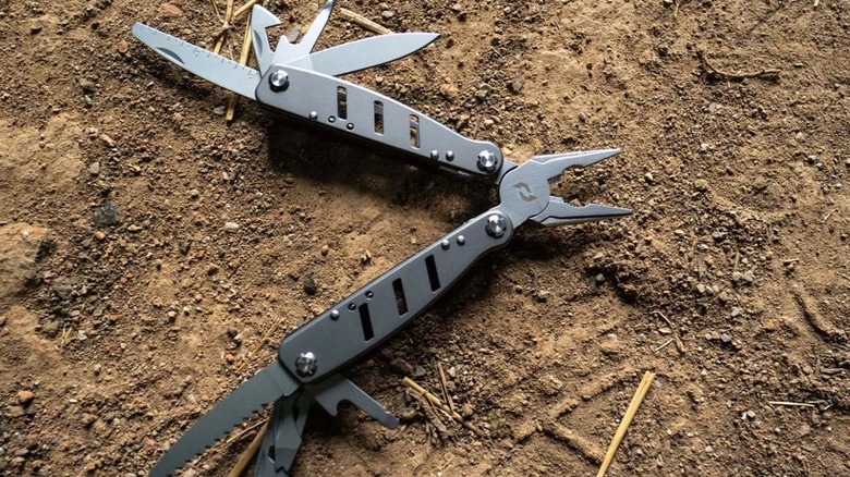 Schrade multi-tool open on dirt