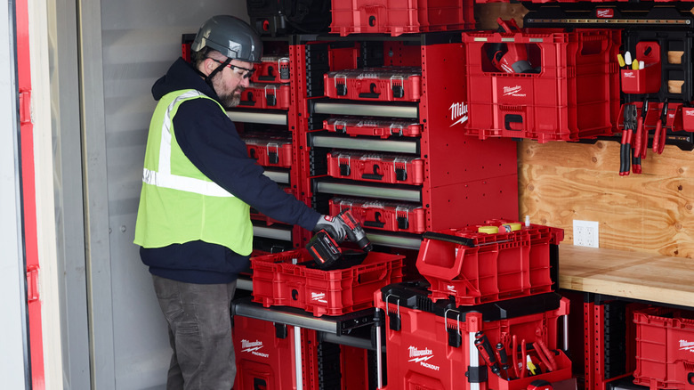 A worker placing a tool into a Packout crate.