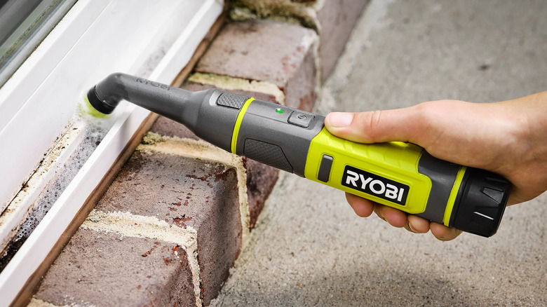 Ryobi USB Lithium detail scrubber cleaning a patio door frame