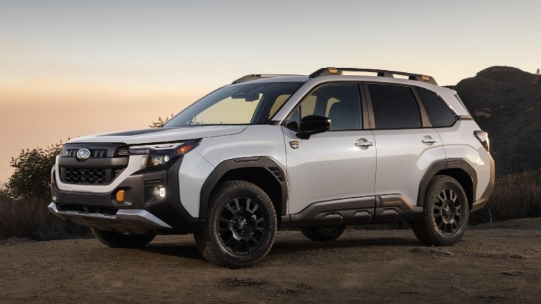 White Subaru Forester in a desert at sunset