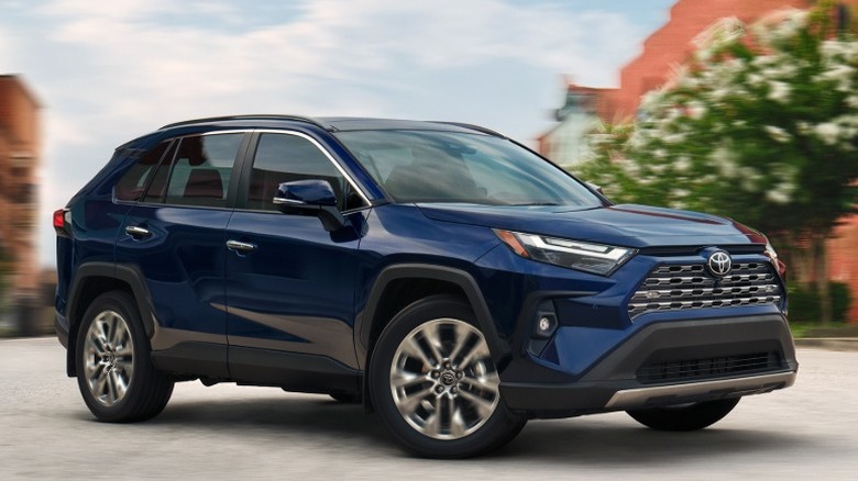 Blue Toyota RAV4 cornering in an urban environment