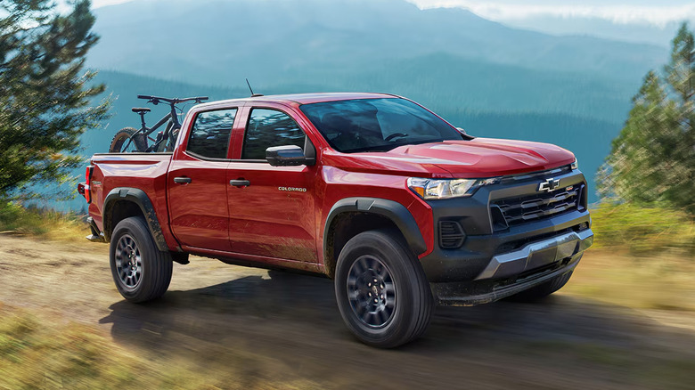 A side on action shot of a red 2025 Chevrolet Colorado driving