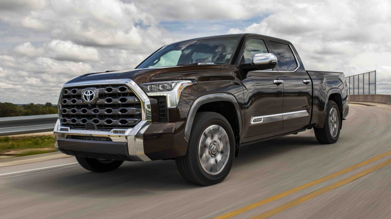 A side on shot of a red 2025 Toyota Tundra driving