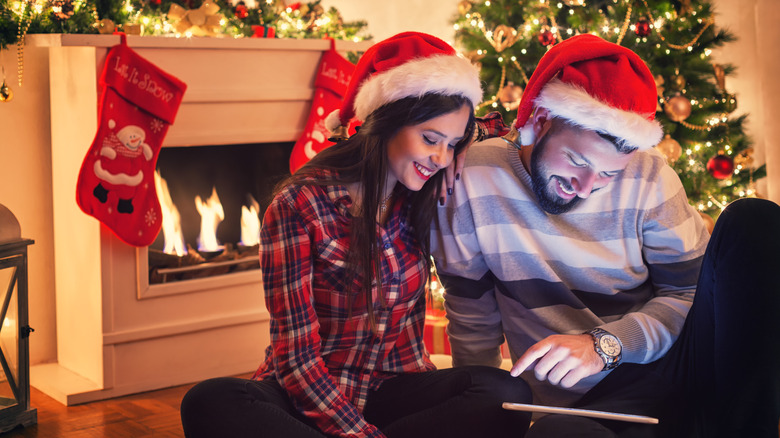 couple opening stocking stuffer with tech inside