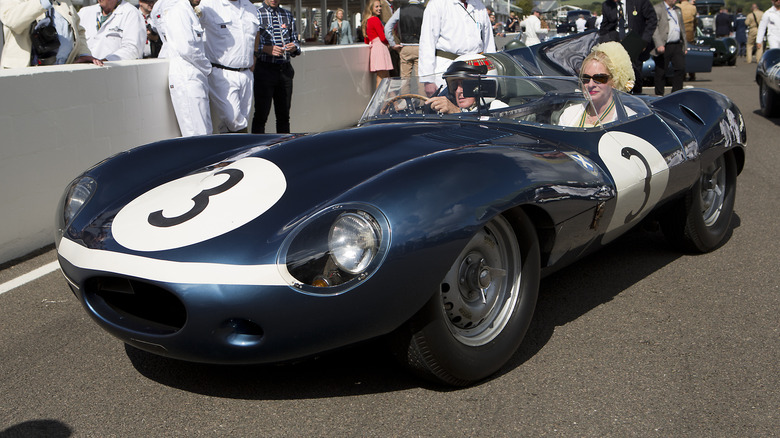 Jackie Stewart sitting in a Jaguar D-Type.