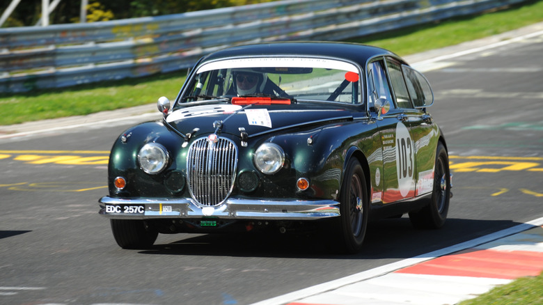 A Jaguar Mark II driving on a track.