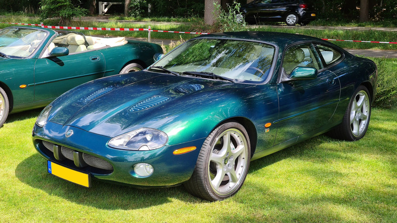 Jaguar XKR (X100) at a car meetup, on grass.