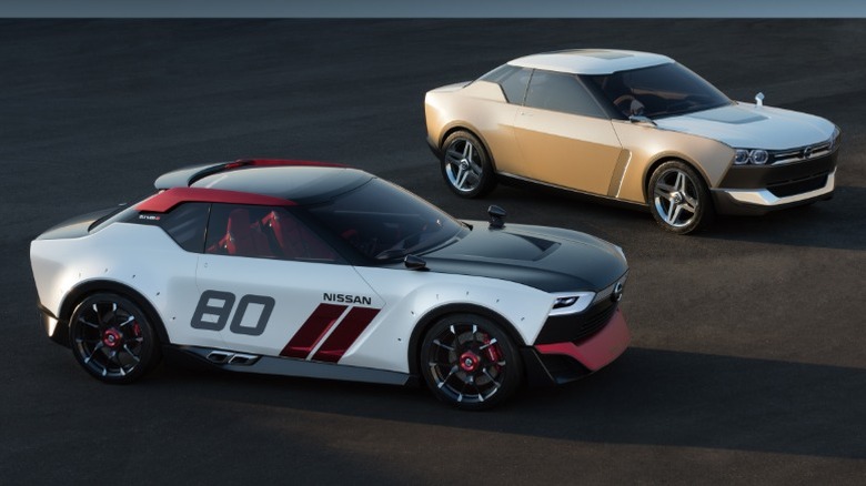 Nissan IDx Nismo and IDx Freeflow parked on asphalt