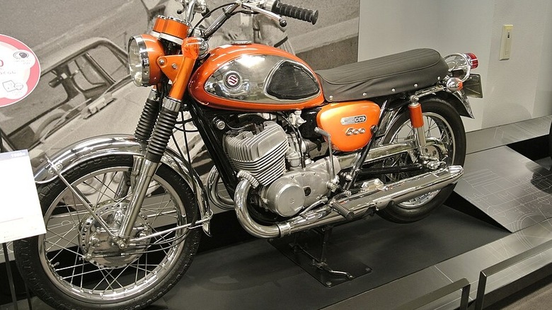 orange Suzuki T500 on display inside a building