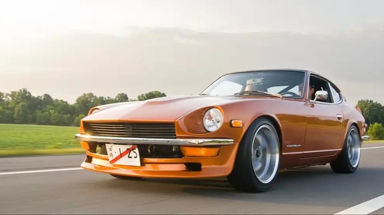 an orange Datsun 240Z on a road