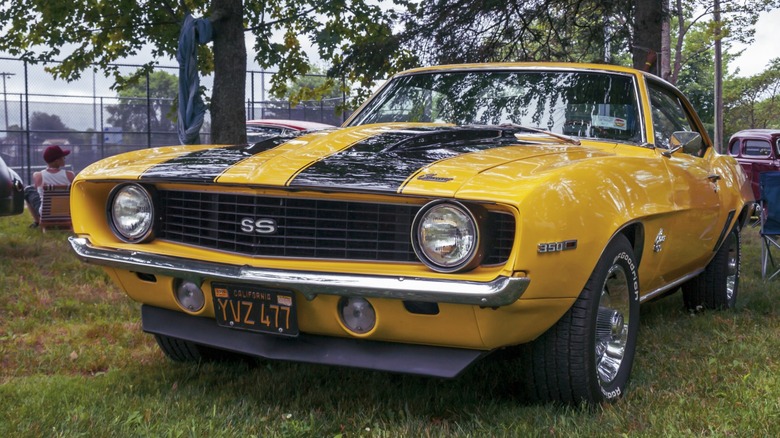 a 1969 Chevrolet Camaro parked at a car show