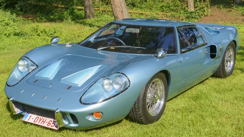 a blue Ford GT40 Mk III parked on some grass