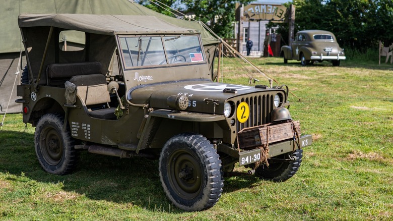 a WW2 Jeep parked inside a camp in France