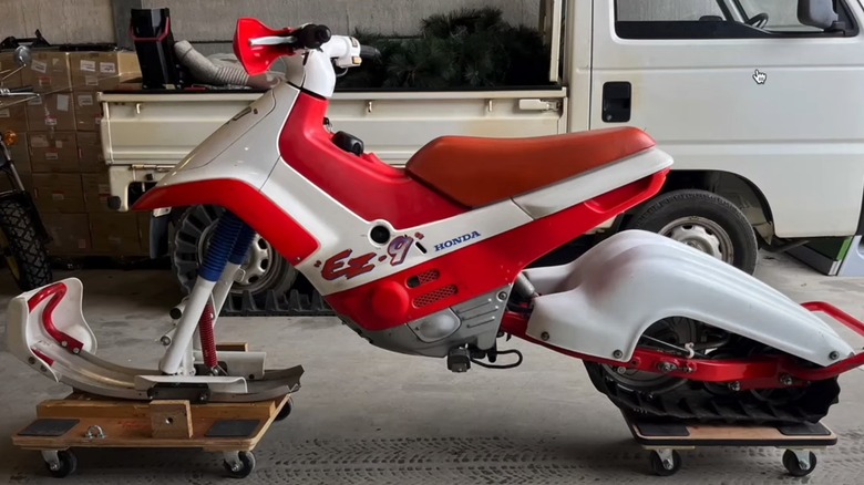 Honda EZ-Snow in garage sitting in front of kei truck