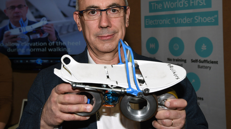 Paul Chavand displays the prototype Rollkers transportation device he invented.