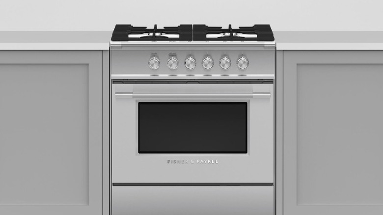Fisher & Paykel OR30SCG4X1 range in between gray cabinets