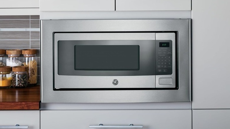 GE Profile PEM31SFSS microwave in kitchen cabinet