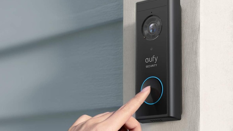 Hand touching Eufy Video Doorbell S220