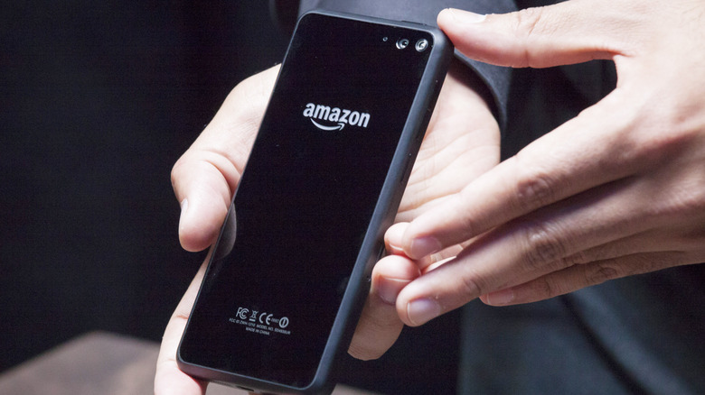 A person holding up the Amazon Fire phone