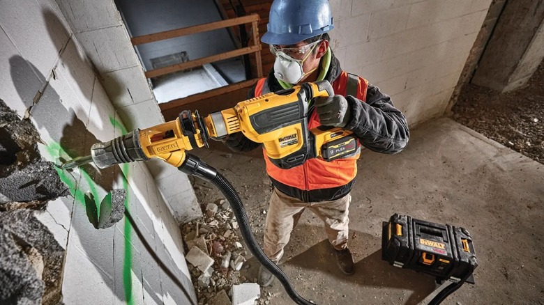 Man demolishing with DeWalt DCH614B Rotary Hammer
