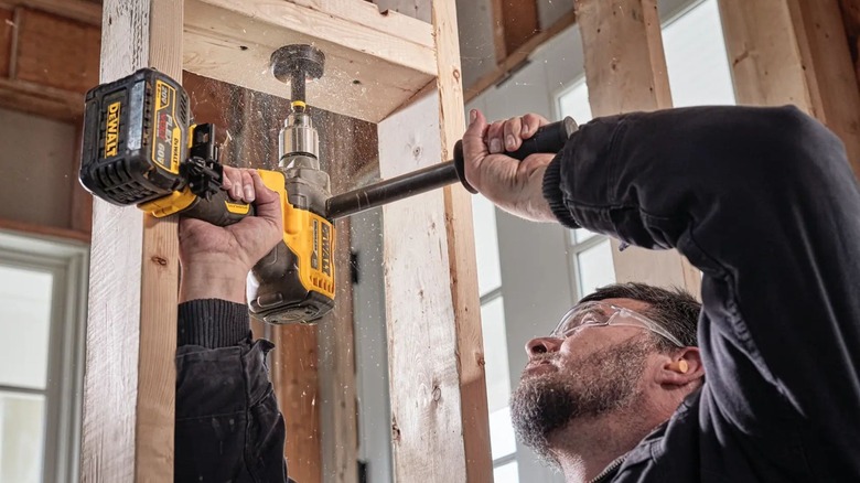 Man using DeWalt DCD130B Mud Mixer Drill