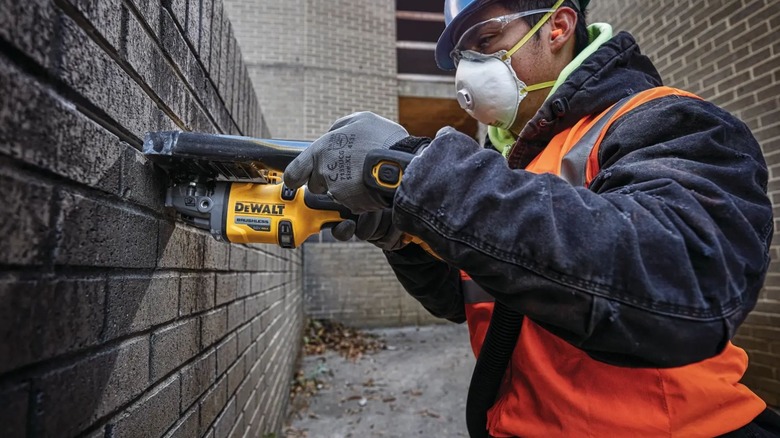 Man using DeWalt DCG418B Small Angle Grinder