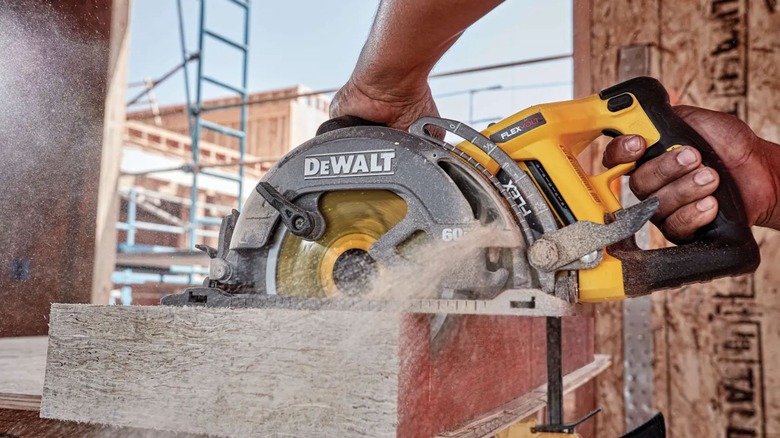 Man using DeWalt DCS577B Wormdrive Style Circular Saw