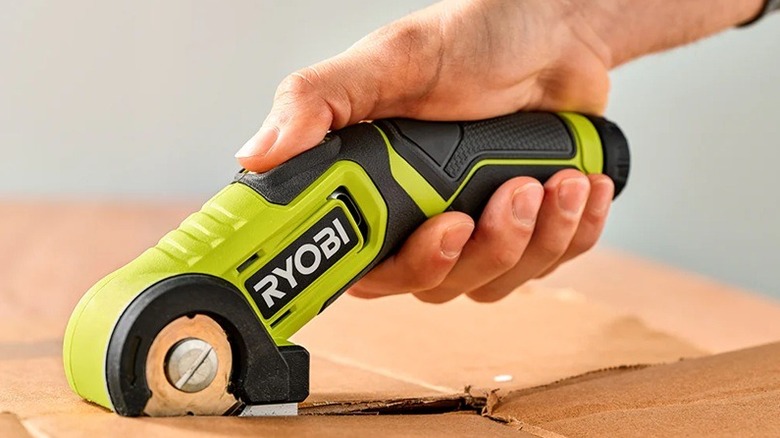Person using Ryobi power cutter