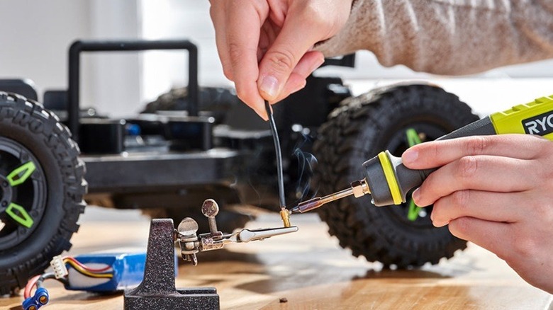 Person using Ryobi soldering pen