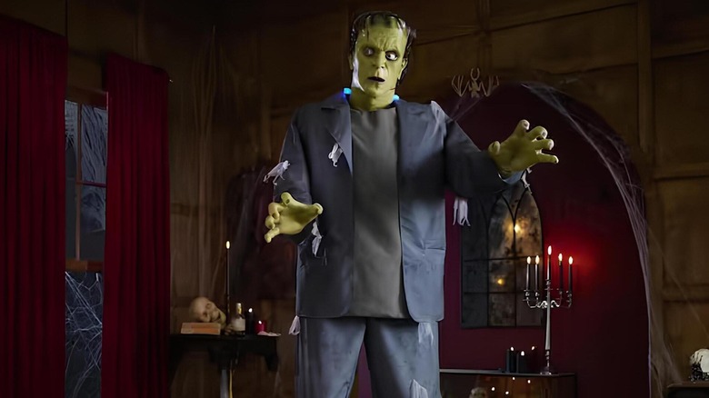 A frankenstein's monster in a spooky candlelit room