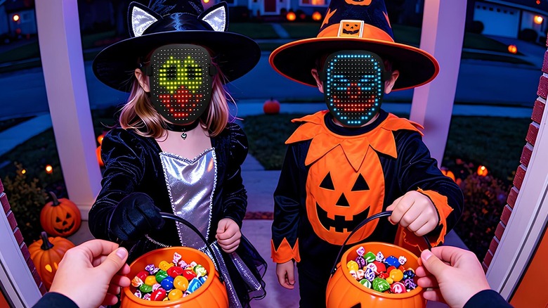 Trick-or-treaters with LED masks and bowls of candy