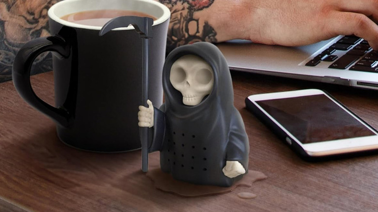 The Genuine Fred Grim Steeper Tea Infuser next to a fresh brew.