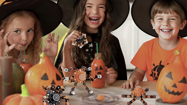 Children playing with fidget spinners at Halloween.
