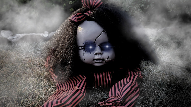 The creepy Haunted Hill Farm Crawling Baby Doll with eyes lit up.