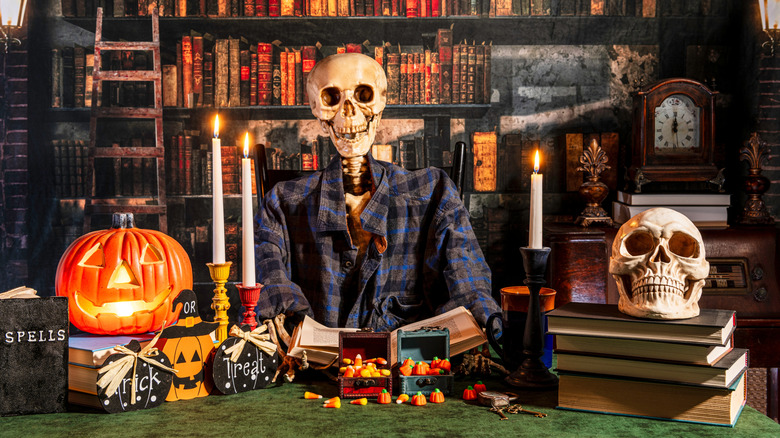 Halloween trick or treat with skeleton and an old library in the background.